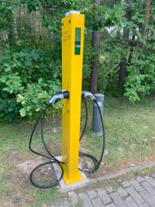 a yellow gas pump with a hose attached at Viisnurga Puhkemajad in Uulu