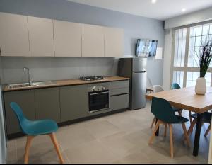 a kitchen and dining room with a table and chairs at Playa degli Angeli Scirocco in Gabicce Mare
