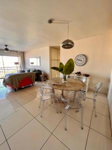 a living room with a table and chairs and a bed at 503 Hawaan View in Durban