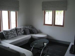 a living room with a couch and a table at Baan Finland - 2 Bedroom apartment in Hua Hin