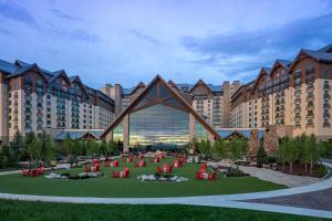 a large building with a group of people in a park at Gaylord Rockies Resort & Convention Center in Aurora