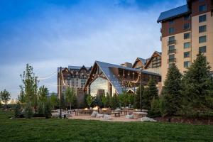 a building with a park in front of a building at Gaylord Rockies Resort & Convention Center in Aurora