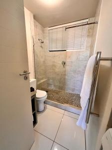 a bathroom with a shower and a toilet at 503 Hawaan View in Durban