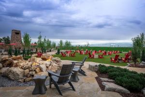 a patio with red chairs and a fire pit at Gaylord Rockies Resort & Convention Center in Aurora