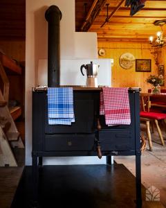 a stove with two towels on the front of it at Waldhütte Kosak in Trofaiach