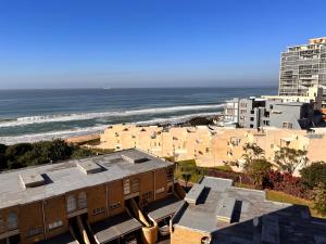 a view of the beach and buildings and the ocean at 503 Hawaan View in Durban