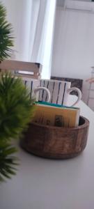 a wooden basket with books in it next to a christmas tree at Apartments and Rooms Batoš in Zavala
