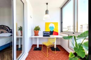 a room with a desk and a bed and a window at Elegant Apartment Overlooking Historic Loulé in Loulé