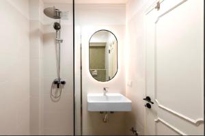 a bathroom with a sink and a mirror at Loulé Old Town Apartment in Loulé +15 photos