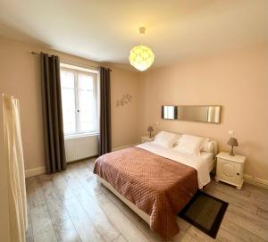 a bedroom with a large bed and a window at L'ambassadeur - Colmar centre in Colmar