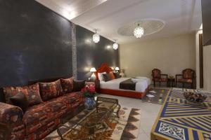 a living room with a couch and a bed at Riad Mandana & Spa in Marrakesh