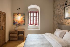 a bedroom with a bed and a window at FOS Hydra residence in Hydra