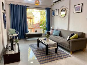 a living room with a couch and a table at Angel Views 201, Chapel Road, Bandra West by Connekt Homes in Mumbai