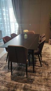 a dining room table with chairs and a vase of flowers on it at GTC Posh Hideaway in Westlands in Nairobi