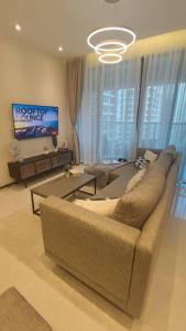 a living room with a couch and a tv at GTC Posh Hideaway in Westlands in Nairobi