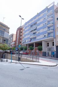 an empty street in front of a large building at Myflats Premium Sunset Campello in El Campello