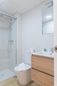 a bathroom with a shower and a toilet and a sink at Myflats Premium Sunset Campello in El Campello