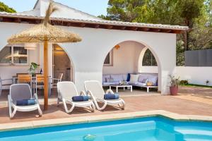 a villa with a swimming pool and a patio at Casa Abril in Santanyi