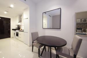 杜拜的住宿－SHH - Funished Studio with Balcony in Damac Celestia, Dubai South Near Expo，一间带桌椅和镜子的用餐室