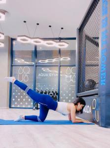 a woman doing a push up exercise in a gym at The Arena Cam Ranh Resort all Luxury Service in Miếu Ông
