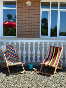 two beach chairs sitting in front of a house at Villa MATE & Villa LUKA in Ureki
