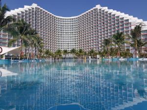 a large resort building with a large swimming pool at The Cam Ranh Resort all Luxury Service in Miếu Ông
