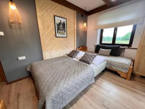 a bedroom with two beds and a window at Villa Tatrydom in Zakopane