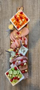 a cutting board with different types of food on it at Zen in loft in Embry