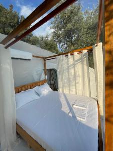 a bedroom with a bed in a tent at La Perle Palase in Palasë