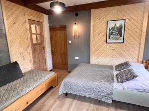 Łóżko lub łóżka w pokoju w obiekcie Villa Tatrydom