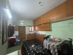 a room with a table and a kitchen with a tableablish at Vacation Rental Home in Kondapalle