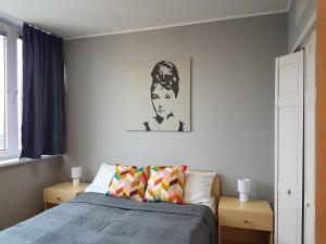a bedroom with a bed and a picture on the wall at CEU Konferencia Központ in Budapest +55 photos