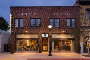 a brick hotel with a sign that reads caffe at HOTEL CERRO, Autograph Collection in San Luis Obispo