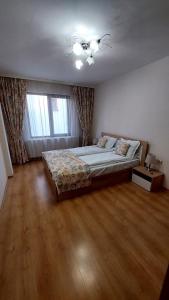 a bedroom with a bed and a ceiling fan at Апартамент Радост in Bansko