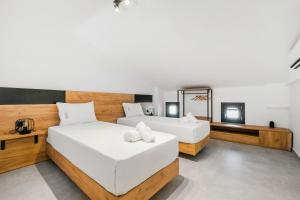 a bedroom with two beds and a mirror at Villa Irene in Polychrono