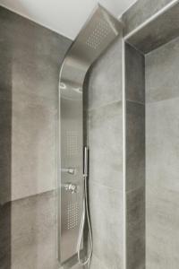 a shower with a shower head in a bathroom at Villa Irene in Polychrono +109 photos