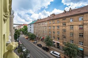 a view of a city street with buildings and cars at Jaromirova 9 in Prague