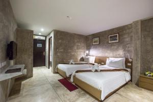 Tempat tidur dalam kamar di Buddy Boutique Inn