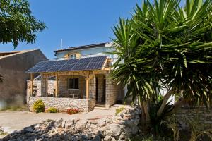 a house with solar panels on the roof at Robinson house T'n'T in Hvar
