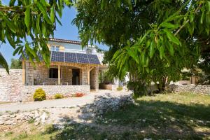 a house with solar panels on the roof at Robinson house T'n'T in Hvar