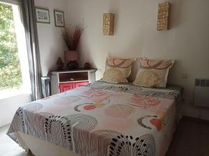 a bedroom with a bed and a window at Villa La Croisette in Sainte-Maxime