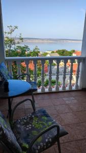 a balcony with a table and chairs and a view of the ocean at Apartments Veni Up in Starigrad