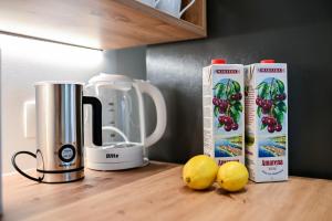 a counter with a blender and some lemons on a table at Apartman Maraška in Zadar