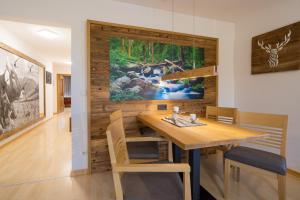 a dining room with a table and a painting on the wall at Ferienwohnung Alpentraum-Panorama Chalet in Oberstdorf