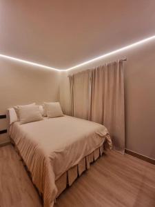 a bedroom with a large bed with a window at Acacias 841 A in Almancil