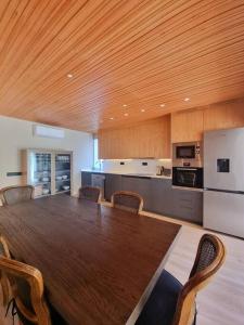 a kitchen with a large wooden table and chairs at Acacias 841 A in Almancil