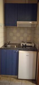 a small kitchen with a sink and a stove at Eirini's Hause in Nea Moudania +94 photos