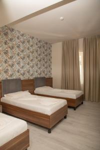 Postel nebo postele na pokoji v ubytování Hotel Dyrrah