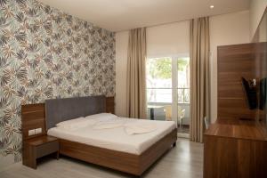 Postel nebo postele na pokoji v ubytování Hotel Dyrrah
