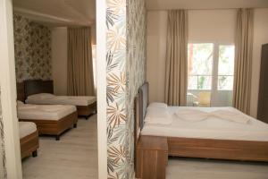 Postel nebo postele na pokoji v ubytování Hotel Dyrrah